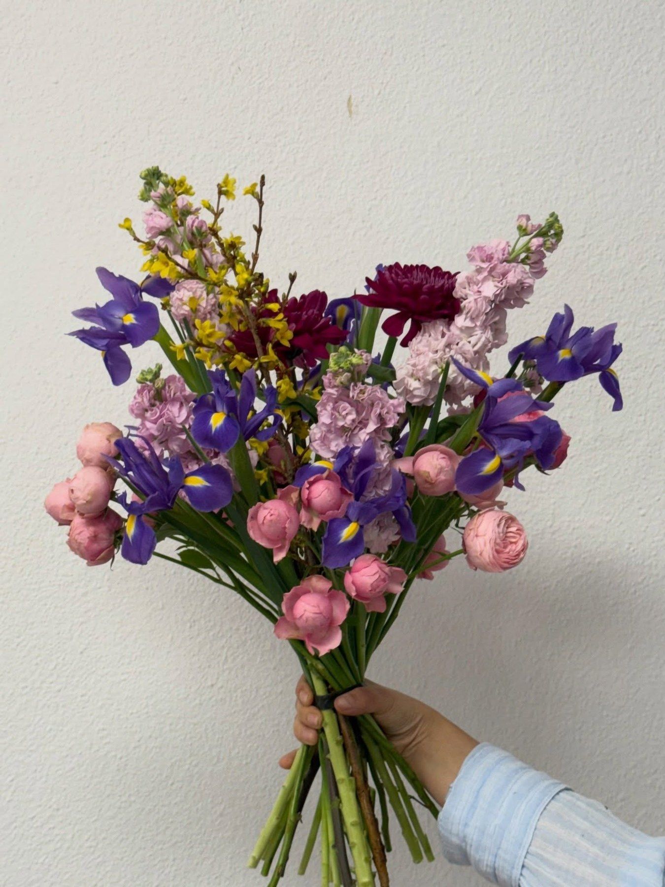 Ramo silvestre de primavera con iris, dalias, ranúnculos y alhelí